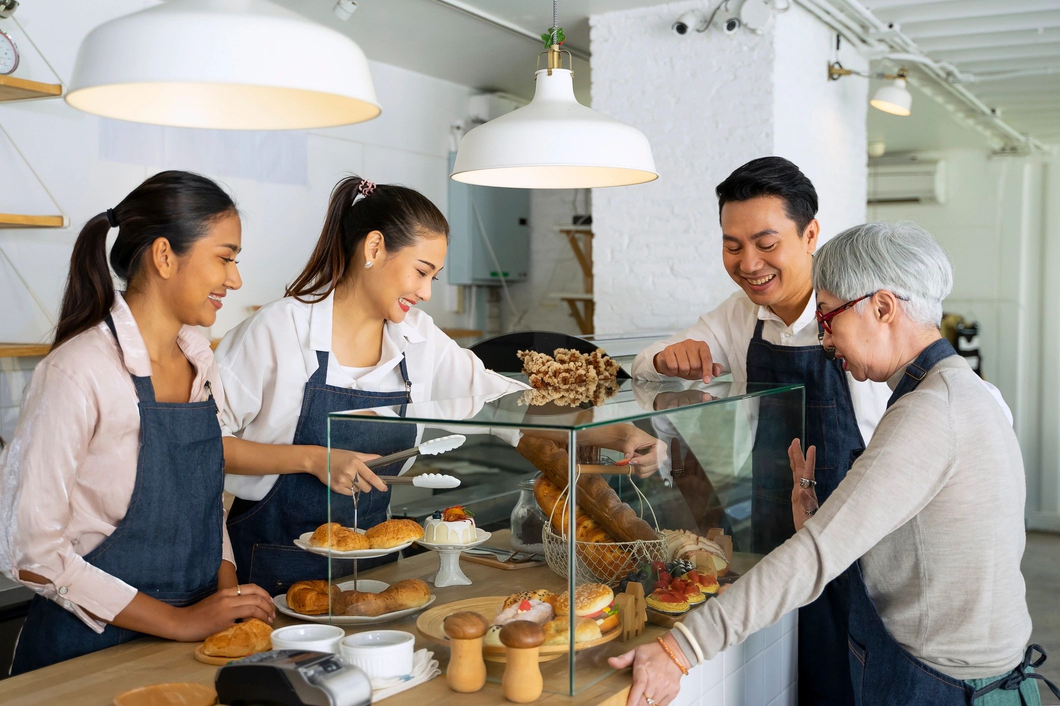 Bakery team members working together behind the counter