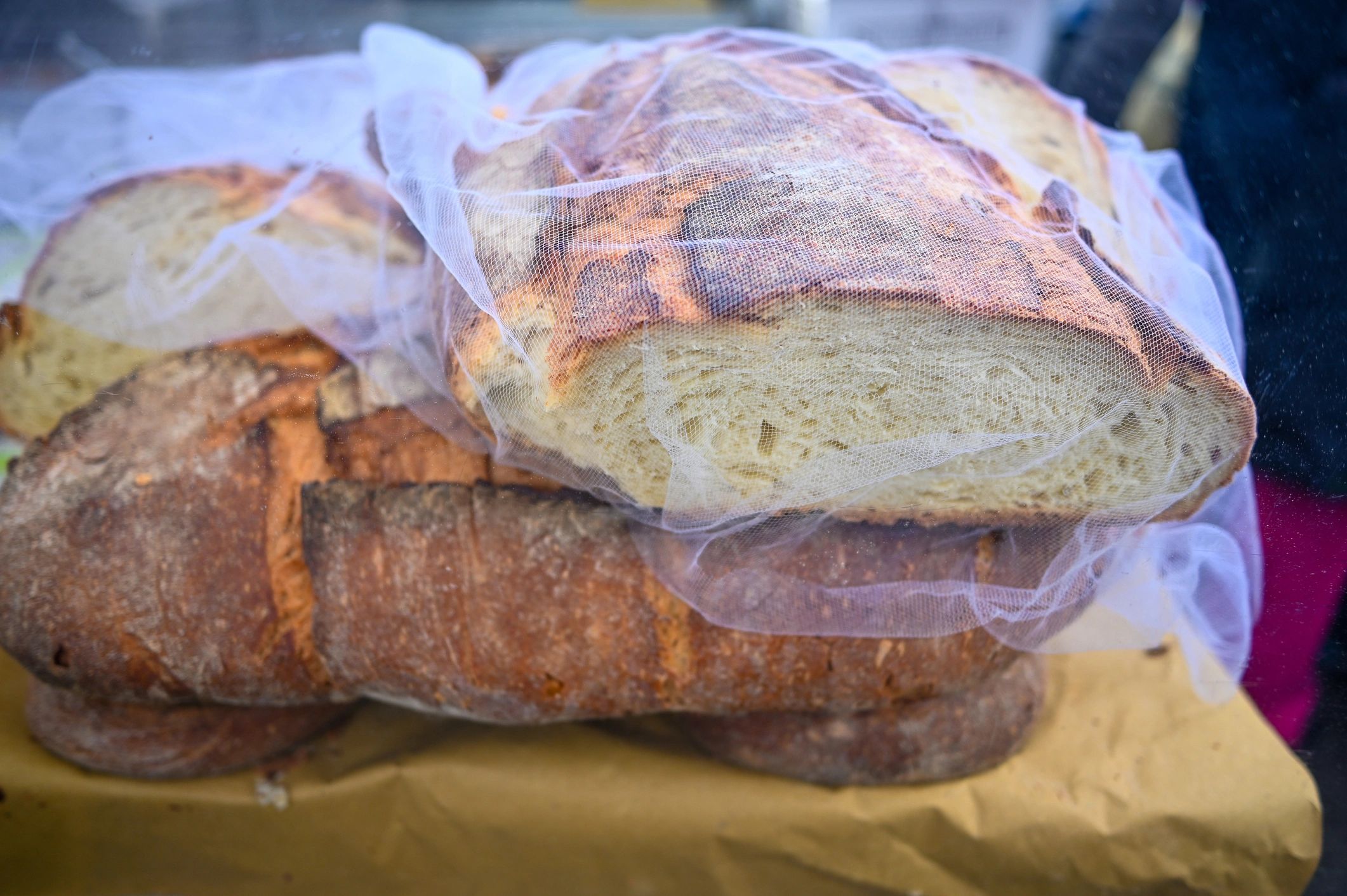 Rustic sourdough loaves displayed at a market stall